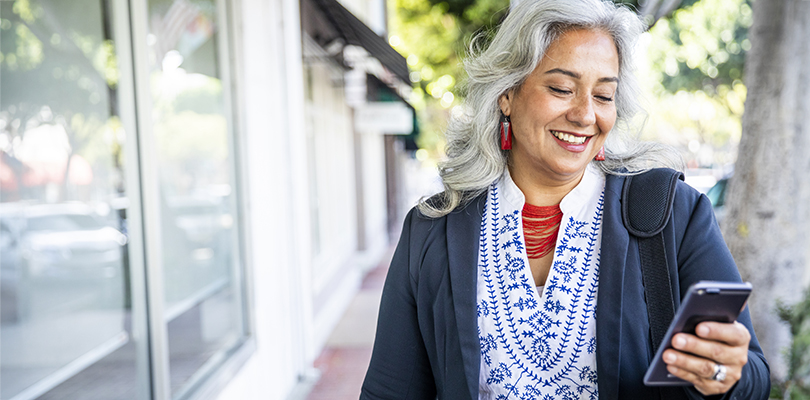 Retired CalPERS member using a cell phone to access important information
